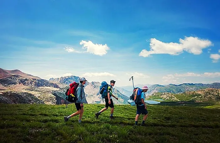 Three (3) people hiking on the Continental Divide Trail (CDT) in Colorado