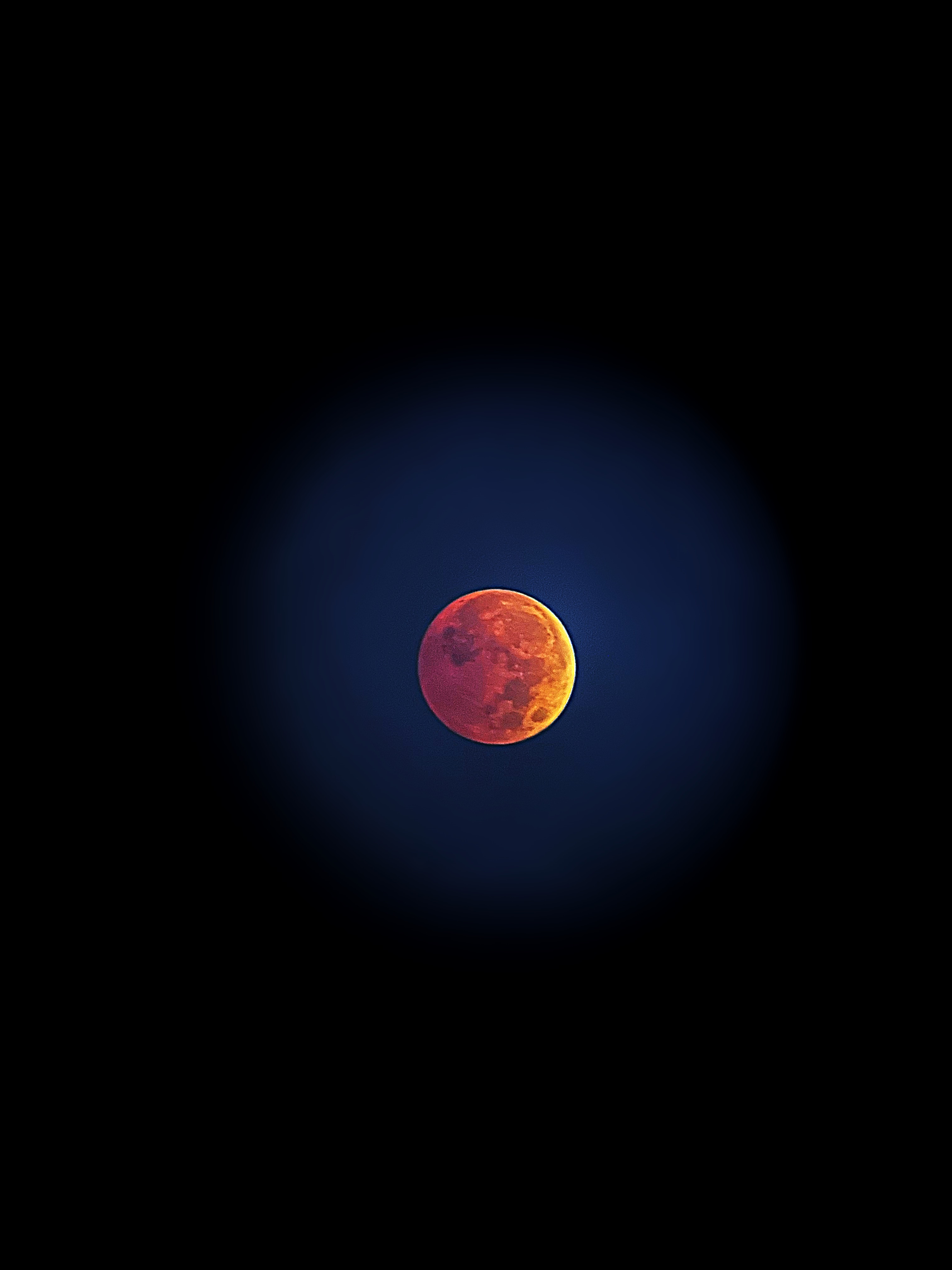 Another lunar eclipse photo. This depicts the moon during a lunar eclipse, the whole moon is tinted a redish orange.